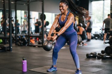 African American woman working out with a kettle bell